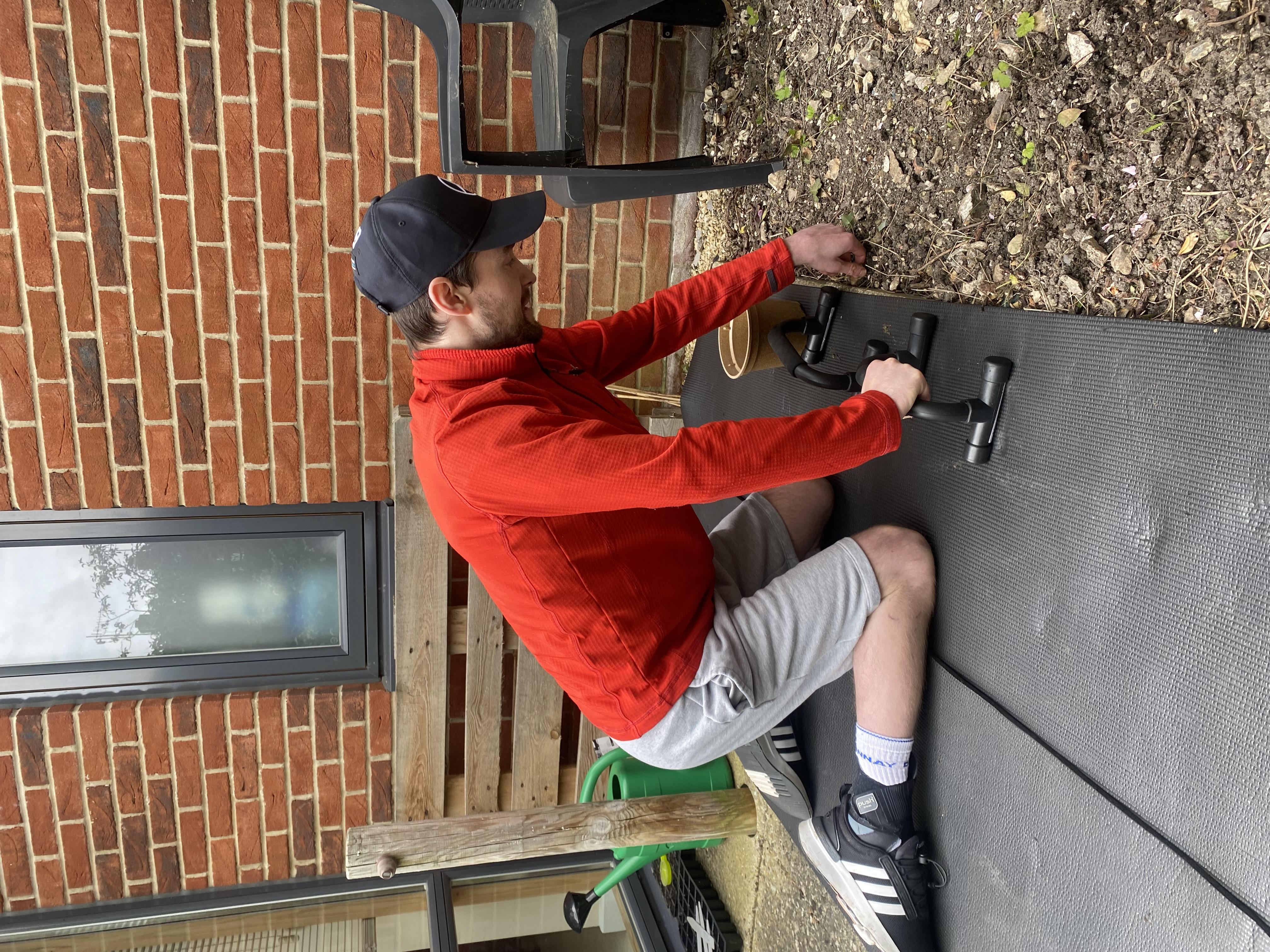 Spinal cord injury patient on needs with hand supports doing gardening